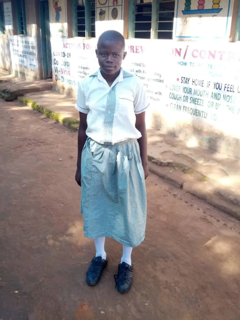 Supported schoolgirl standing at her school