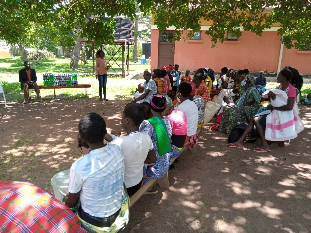 Community members listening during an outdoor health talk